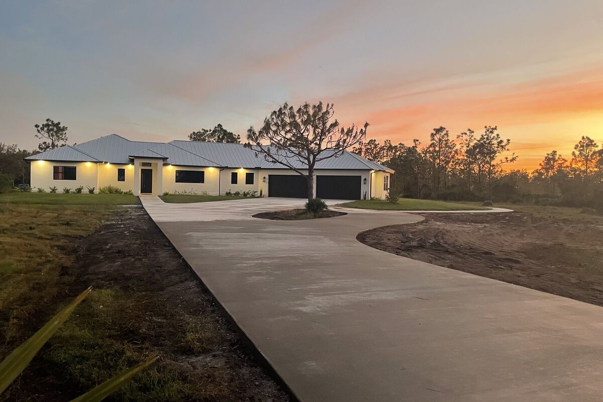 Custom home frontage at dusk with a circular drive