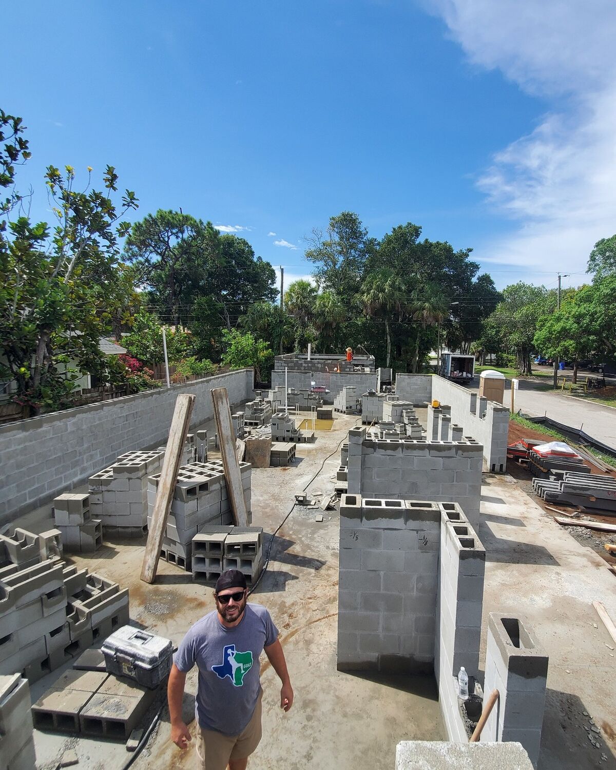 Ryan Ingle of Beach Star Construction standing on a block-wall foundation during construction